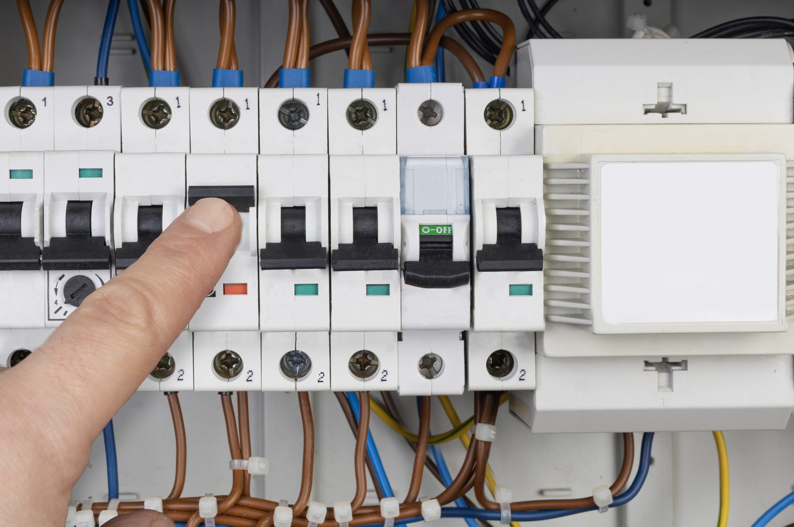 Technician testing a circuit breaker panel